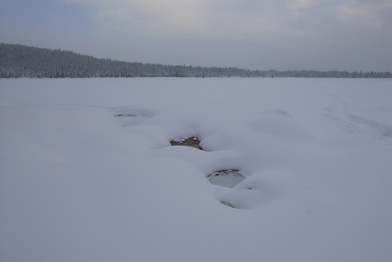 Open water on a frozen river in the boreal forest
