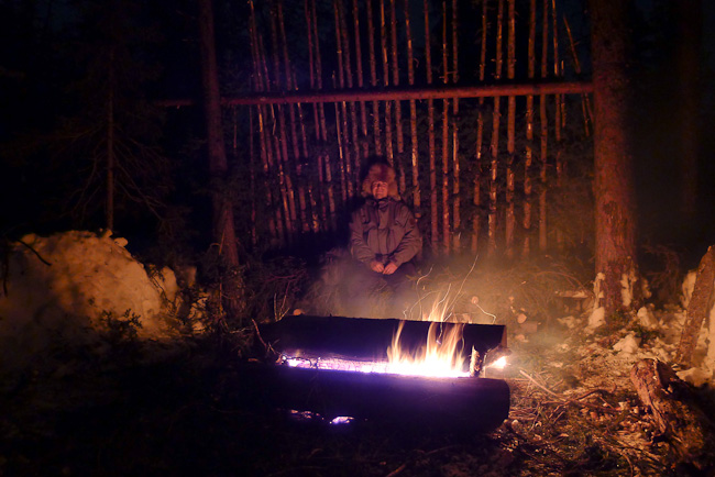 Boreal forest lean-to with long-log fire