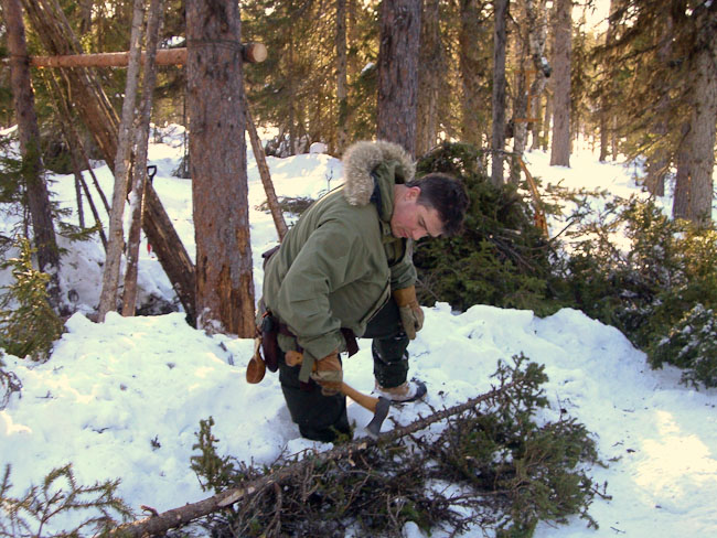 Paul Kirtley using axe in boreal forest