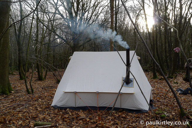 Heated tent in winter forest but no snow