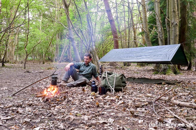 Bushcraft-harrastaja, jonka leiri on perustettu metsään