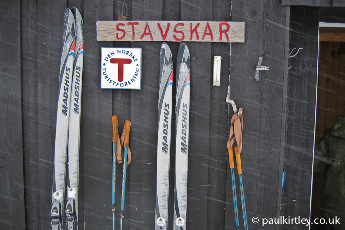 Madshus Glittertind mountain skis and Swix Mountain Poles up agains the wall of a mountain hut