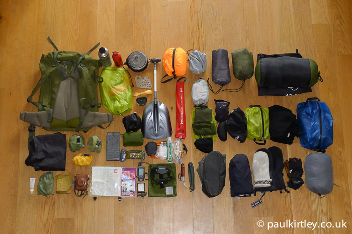Outdoor equipment for ski touring in Norway, laid out carefully on the floor