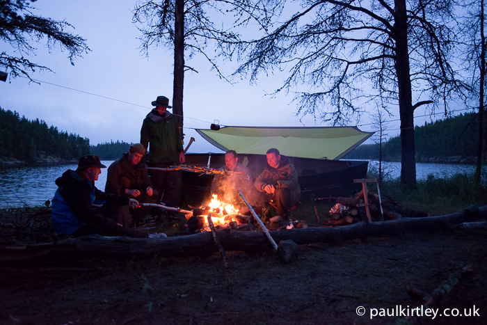 Men in a tarp with a fire in Canada