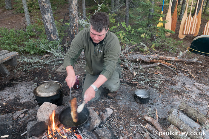 Once both sides are browned, turn the bread back to the first side again.  The fire will have died down a bit now and you can make sure the bread is cooked through. Photo: Amanda Quaine.