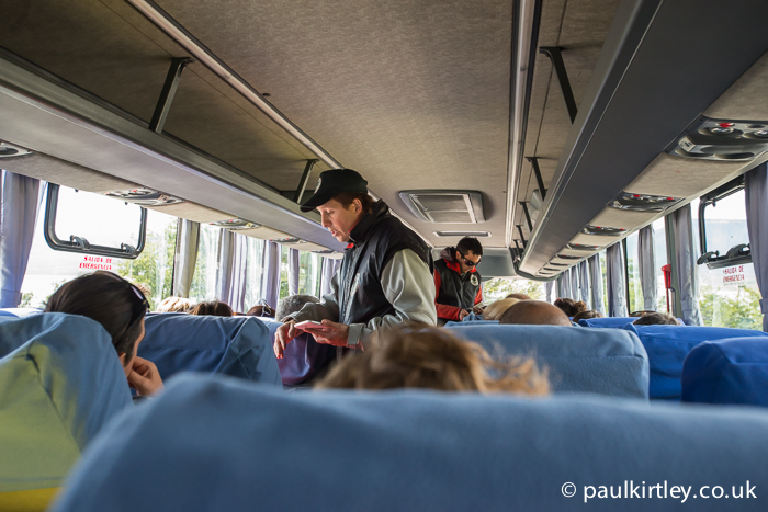 Bus interior with Parque Nacional Los Glaciares officials taking payment of park fees