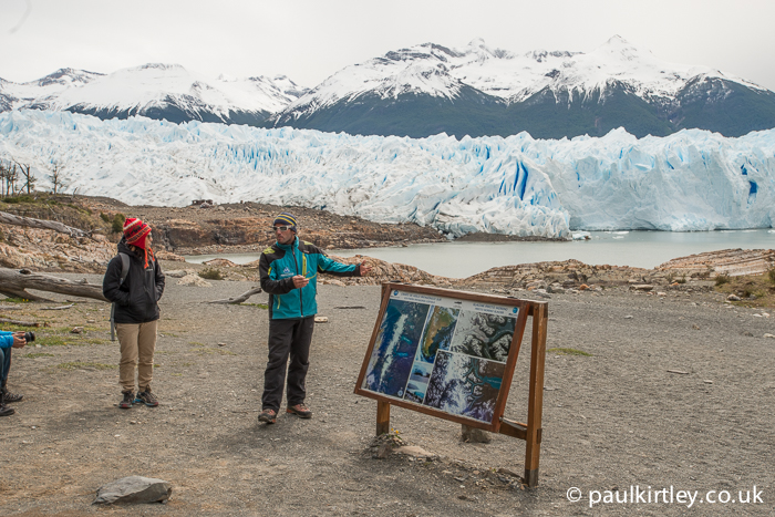 Guide making a presentation on the Perito Moreno glacier, which is in the background