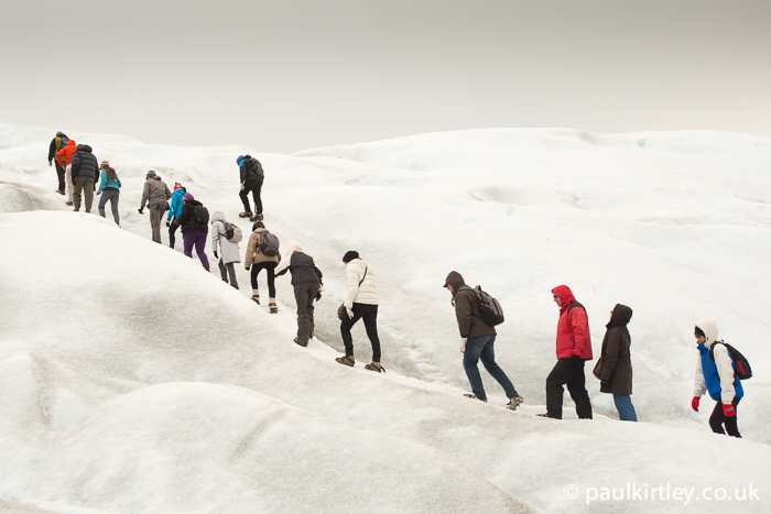 A group of inexperienced people trekking on a glacier