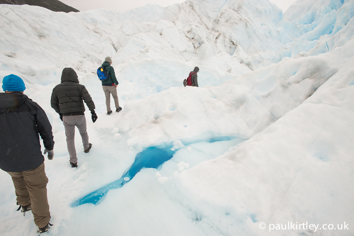 Glacier trekkers pass water on Perito Moreno