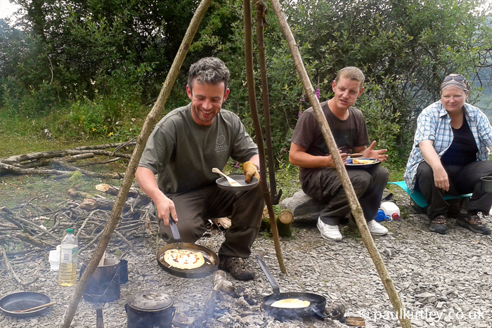 Ben Gray cooking pancakes on a campfire