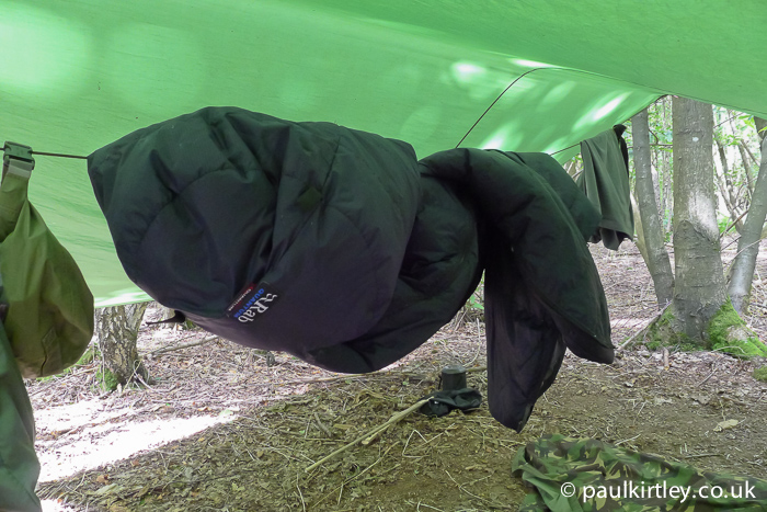 Sleeping bag hanging on line under a tarp