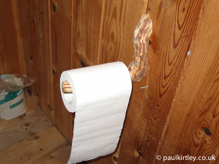 Toilet roll dispenser made from natural stick shape.