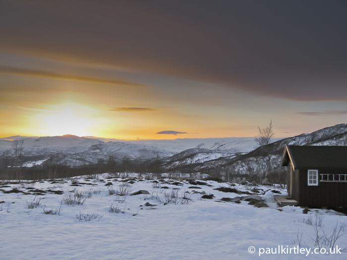 Cabin and sunset in winter mountains Norway