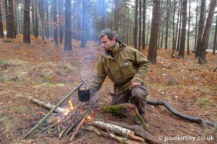 Ben Gray in front of campfire with cooking pot suspended on simple straight pot hanger
