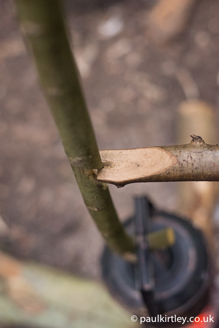 This illustrates the importance of creating the notch on the same side as the hook at the bottom of the hanger.  This allows the centre of the pot to sit directly under the point where the two sticks fit together. Photo: Paul Kirtley