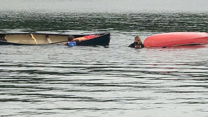 Two canoes capsized with two people in the water