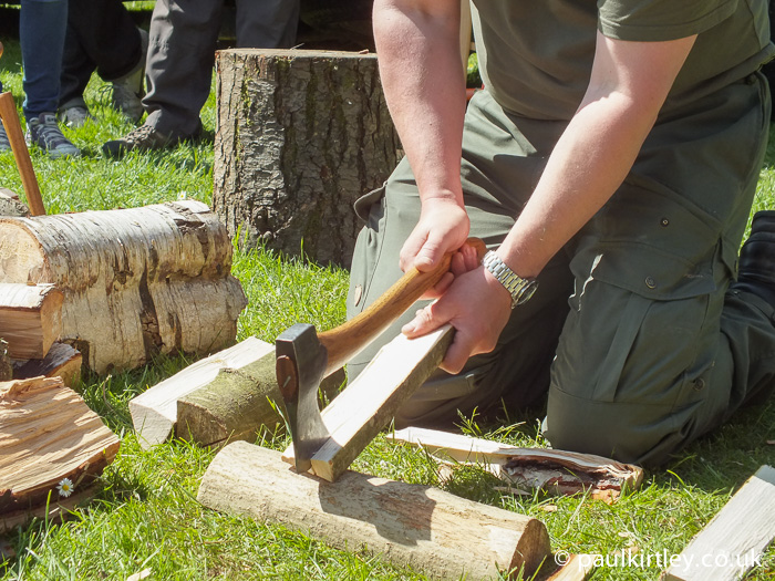 The author demonstrating splitting techniques during an axe technique demonstration from chopping block, log section to a piece of the split wood itself.  Work with what you’ve got, safely using an appropriate technique." 