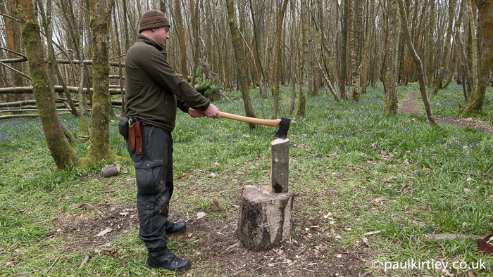 Standing up straight results in the full-size axe striking the top of the log at an angle.