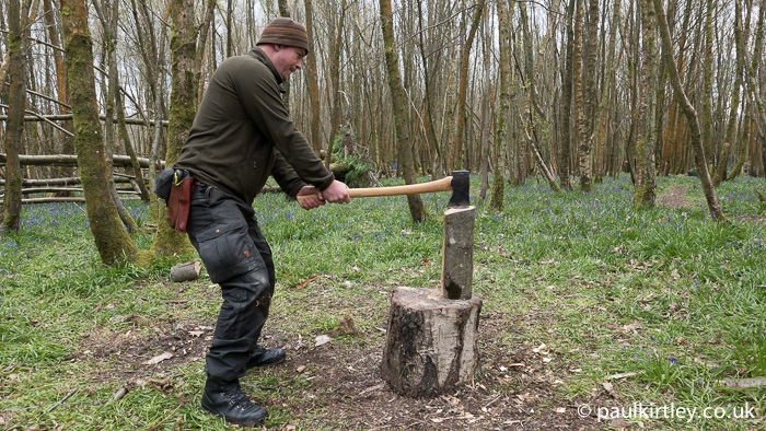 Bending at the knees results in the axe bit striking the top of the log vertically.