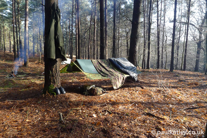 Tarp in sunshine with bivvy bag and sleeping bag draped over the top to air out