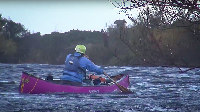 Canoeist on choppy water on a windy day