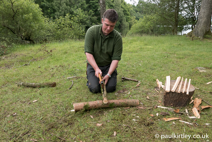 Paul Kirtley splitting small diameter rounds of wood on low log