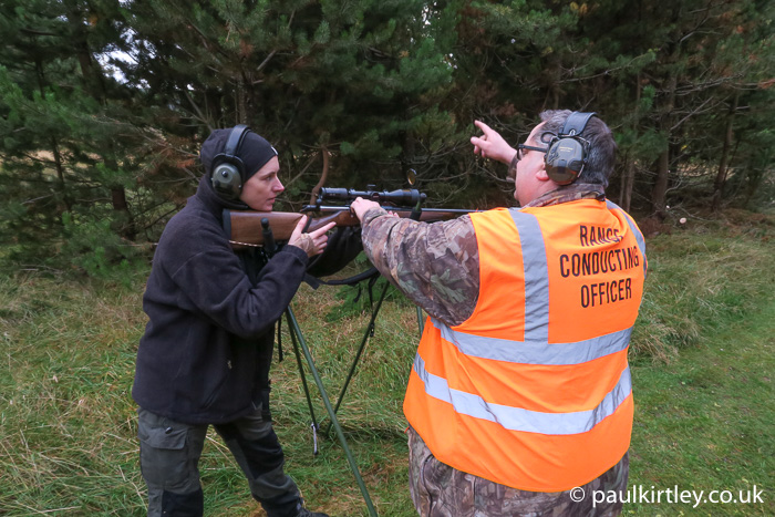 Man teaching lady how to use a .243 calibre deer rifle