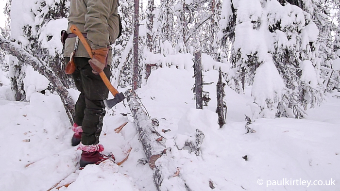 Working with axe on snowshoes.