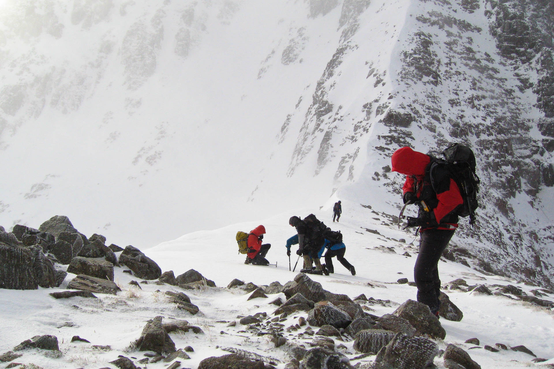 Group walking down ridge in winter conditions in Lochaber 