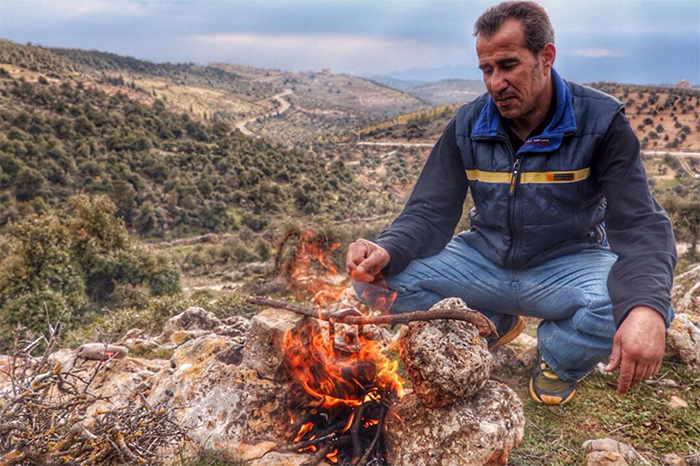 Man making fire in Jordan