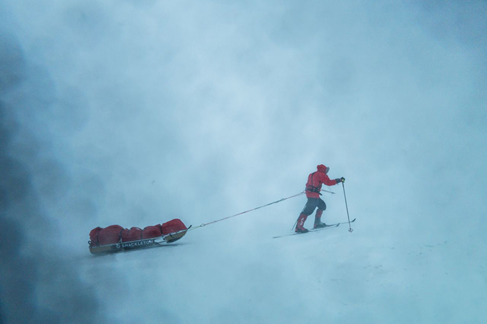 Man pulling pulk in polar conditions