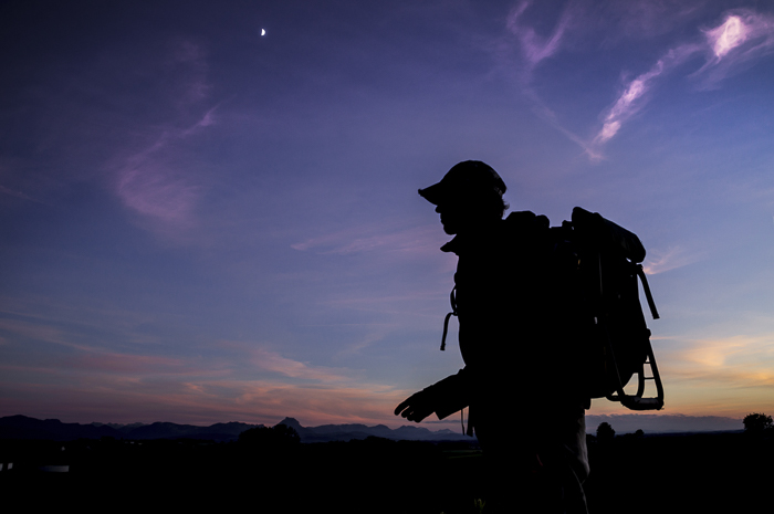 Silhouette of a hiker as they walk at night