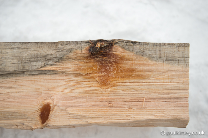 Resin accumulation near knots in pine wood