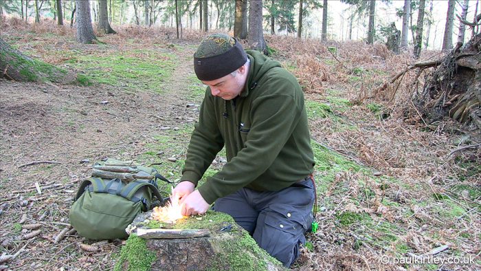 Man creating large sparks with a ferro rod