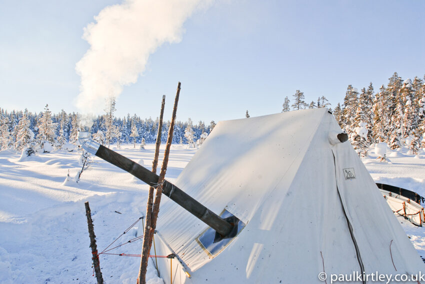 Smoke emanating from the chimney of a SnowTrekker heated tent in Sweden