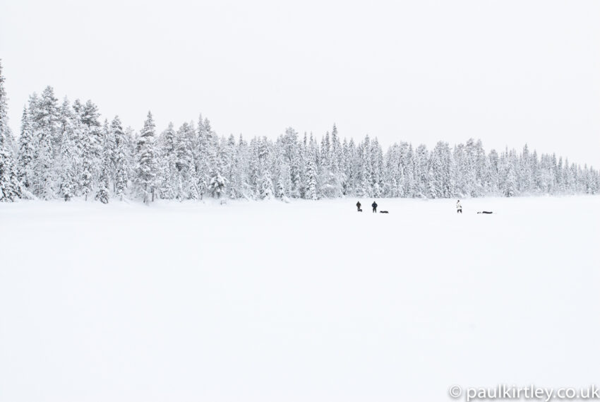 Three men walking deep in a winter wilderness