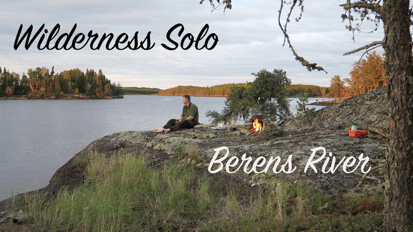 man sitting on rock overlooking lake in Canadian Shield wilderness area