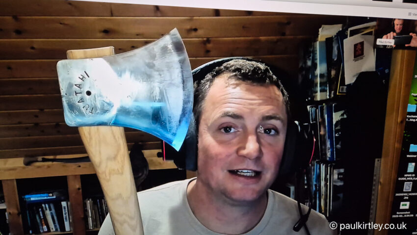 Man holding Tuatahi axe up to the camera